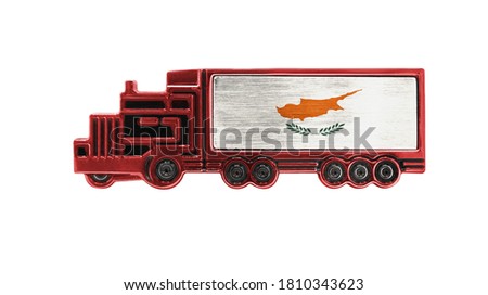 Toy truck with Cyprus flag shown isolated on white background. The concept of cargo transportation between countries.