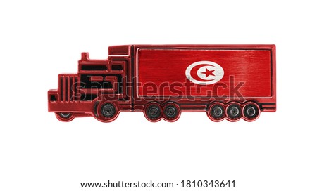 Toy truck with Tunisia flag shown isolated on white background. The concept of cargo transportation between countries.