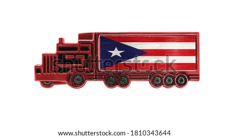 Toy truck with Puerto Rico flag shown isolated on white background. The concept of cargo transportation between countries.
