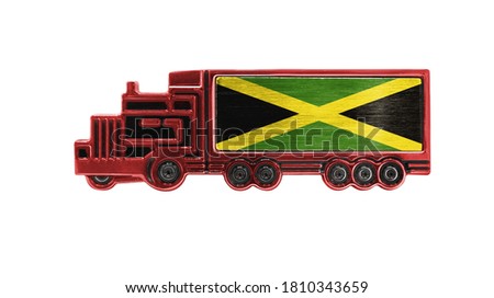 Toy truck with Jamaica flag shown isolated on white background. The concept of cargo transportation between countries.