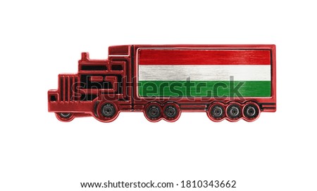 Toy truck with Hungary flag shown isolated on white background. The concept of cargo transportation between countries.