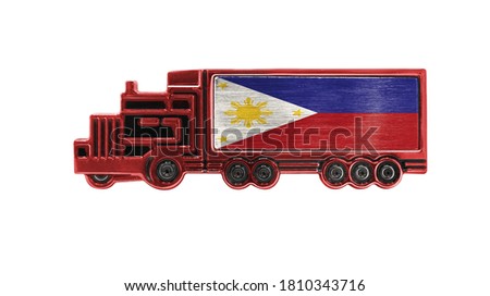 Toy truck with Philippines flag shown isolated on white background. The concept of cargo transportation between countries.