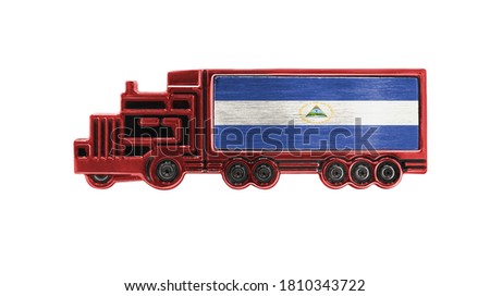Toy truck with Nicaragua flag shown isolated on white background. The concept of cargo transportation between countries.