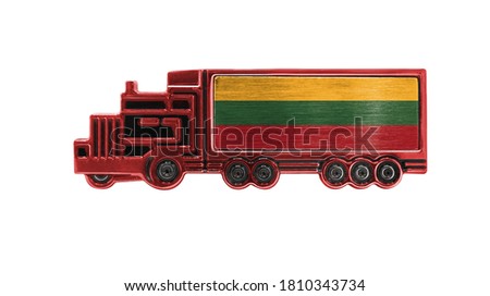 Toy truck with Lithuania flag shown isolated on white background. The concept of cargo transportation between countries.