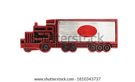 Toy truck with Japan flag shown isolated on white background. The concept of cargo transportation between countries.