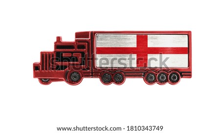Toy truck with England flag shown isolated on white background. The concept of cargo transportation between countries.