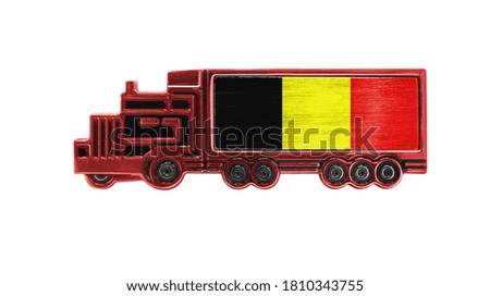 Toy truck with Belgium flag shown isolated on white background. The concept of cargo transportation between countries.