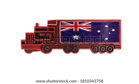 Toy truck with Australia flag shown isolated on white background. The concept of cargo transportation between countries.