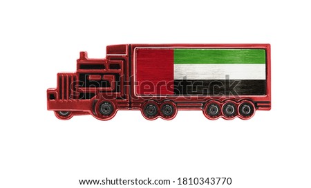 Toy truck with United Arab Emirates flag shown isolated on white background. The concept of cargo transportation between countries.