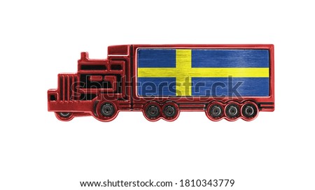 Toy truck with Sweden flag shown isolated on white background. The concept of cargo transportation between countries.