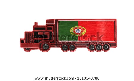 Toy truck with Portugal flag shown isolated on white background. The concept of cargo transportation between countries.