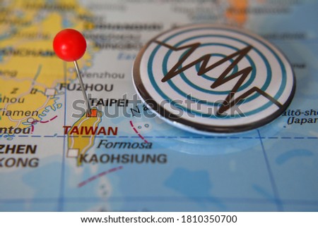 Pin marked Taipei in Taiwan on map with logo earthquake, Taiwan Royalty-Free Stock Photo #1810350700