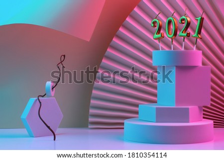 Candles with figures of the new year 2021 on the pyramid of geometric shapes, podium, square. The background is made of fan and cardboard with a bent angle. Illuminated by neon.