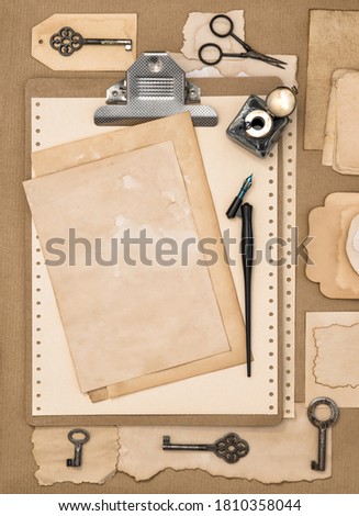 Paper, clipboard and calligraphic writing tools. Vintage style flat lay