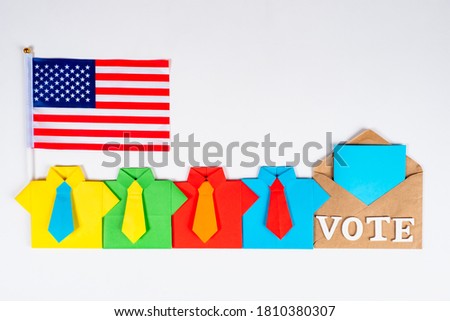 Voting in the us presidential election. A row of origami men next to the Bulletin and the American flag. A polling station in new York. The USA presidential election in 2020. 
