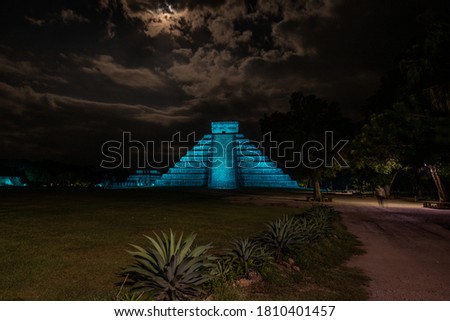 Night view of the Mayan pyramid of Kukulcan El Castillo with blue light at night. Ruins of the ancient Mayan city, one of the most visited archaeological sites in Mexico. Royalty-Free Stock Photo #1810401457