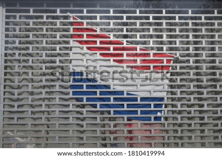 a dutch flag hanging behind a metal roller shuttle