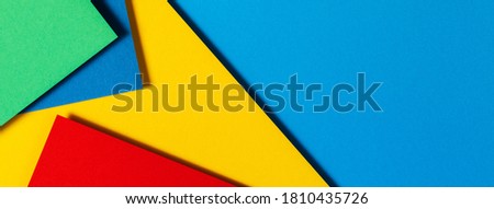 Abstract color papers geometry flat lay composition background with blue, yellow, green and red color tones