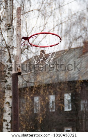 Basketball hoop against the background of a multi-storey buildin