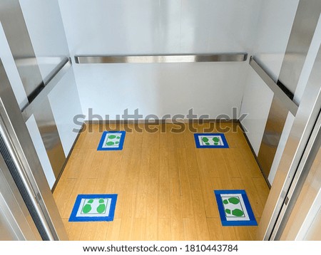 Inside the elevator used to go up and down, a standing position indicator for social distances. During the outbreak of COVID-19, the idea of ​​stopping the spread of the virus at hospitals.