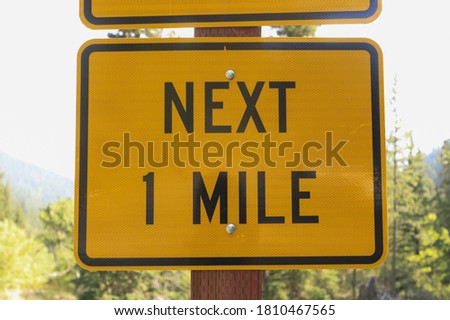next one mile sign on the road