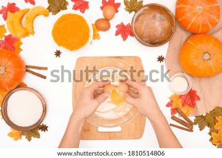 recipe and ingredients for cooking autumn pumpkin cupcakes . top view on a light background. the process of mixing flour, butter, eggs, sugar and pumpkin in a plate.