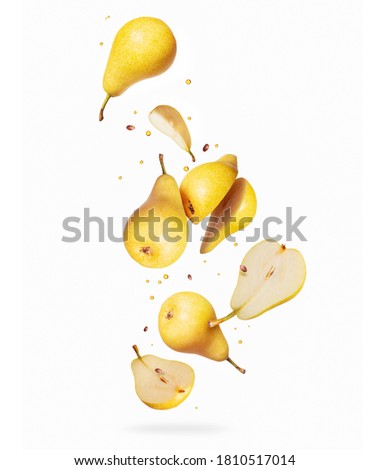 Whole and sliced pears in the air isolated on a white background Royalty-Free Stock Photo #1810517014