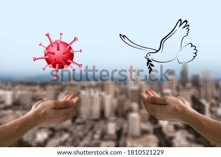 Human hands with free bird and COVID-19  molecule on city background