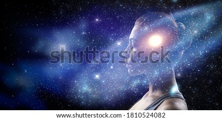 Double exposure portrait of a young woman with galaxy space inside head. Royalty-Free Stock Photo #1810524082