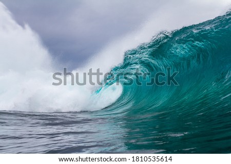 perfect wave breaking on a shallow reef