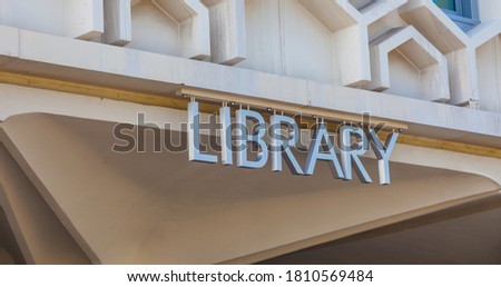 A Library Sign on Top of the Wall