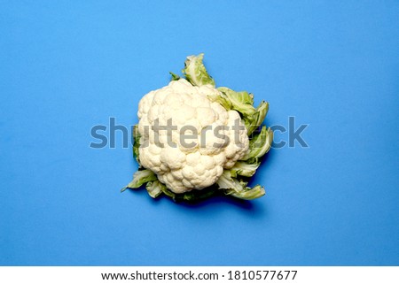 cauliflower top view on blue background. vegetarian or vegan concept. flat lay flat design