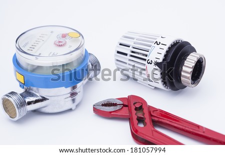 Image shows a red pipe wrench, a water counter and a thermostat isolated on white background Royalty-Free Stock Photo #181057994