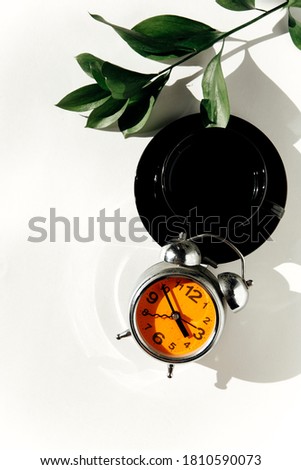 coffee and alarm clock on a white background. the concept of morning. the view from the top