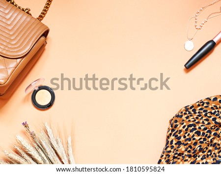 Fashion lifestyle flat lay on the beige background. Clothes and accessories concept top view. Copy space