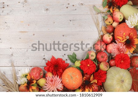 Autumn composition with seasonal pears, pumpkins, apples and flowers on a wooden background, top view, flat lay. Happy Thanksgiving concept, postcard,