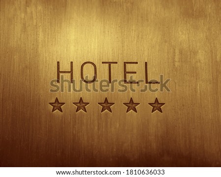 HOTEL  signboard with  five 5 stars metallic plate next to entrance door. 5 five golden stars. empty copy space for inscription. Royalty-Free Stock Photo #1810636033