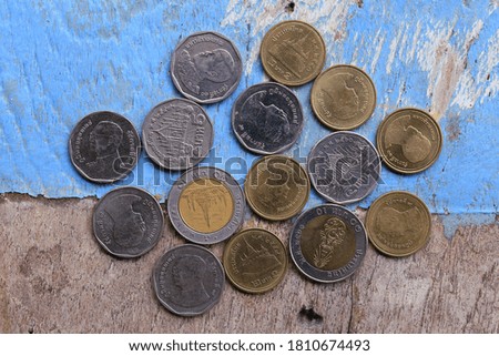 The close-up of a Thai coin placed on a wooden floor selective focus and shallow depth of field
