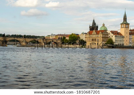 old tower on acre bridge and vltava river in the center of prague and surrounding architecture