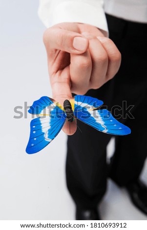 Holding a butterfly on one finger