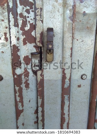 Old rusty steel metal sliding door with handle