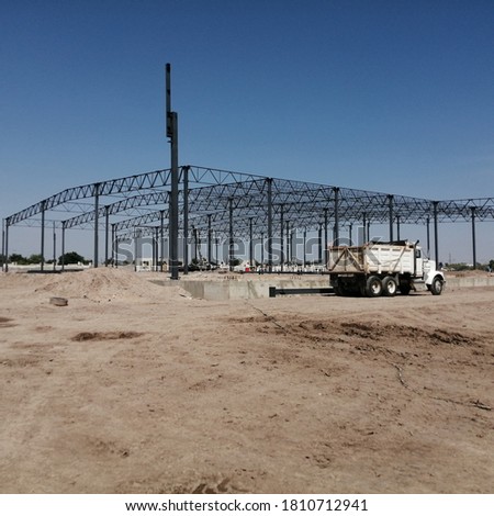 Photography of a Steel frame at a working site during summer, construction that will become a fully operational industrial sector in Torreón, Coahuila, México. 