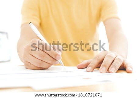 Hand of man signing signature filling in application form document