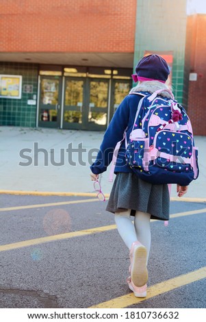 School  girl is going to  school with backpack