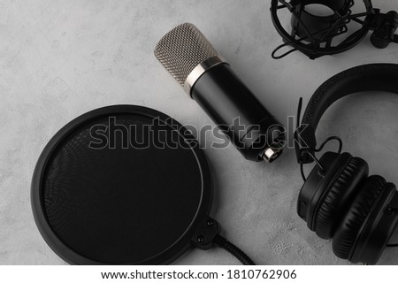 Streaming and podcasts, studio microphone and headphones, top view on white background