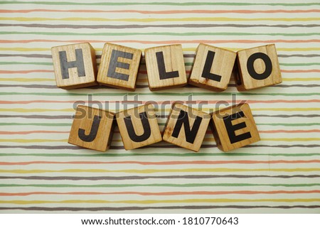 Hello June alphabet letters on colorful stripes background
