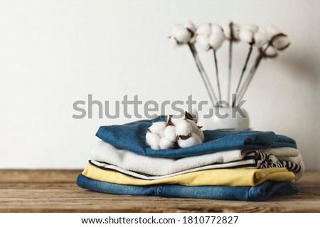 A stack of organic clothing and cotton colors. Eco friendly fabric shop. Royalty-Free Stock Photo #1810772827