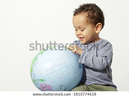 boy holding a globe with white background stock photo