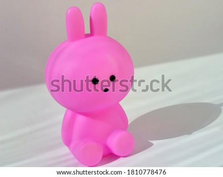 Pink bunny lamp for children on a white background.