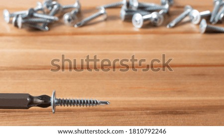 A screwdriver and self-cutters on a brown wooden background. Building tools to repair the house.